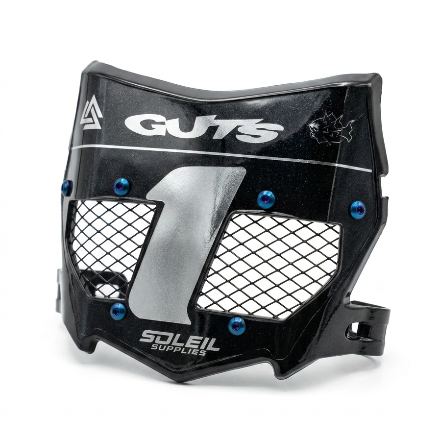 A black protective face guard with a silver mesh pattern and blue screws, branded with 'GUTS' and 'SOLEIL SUPPLIES'.