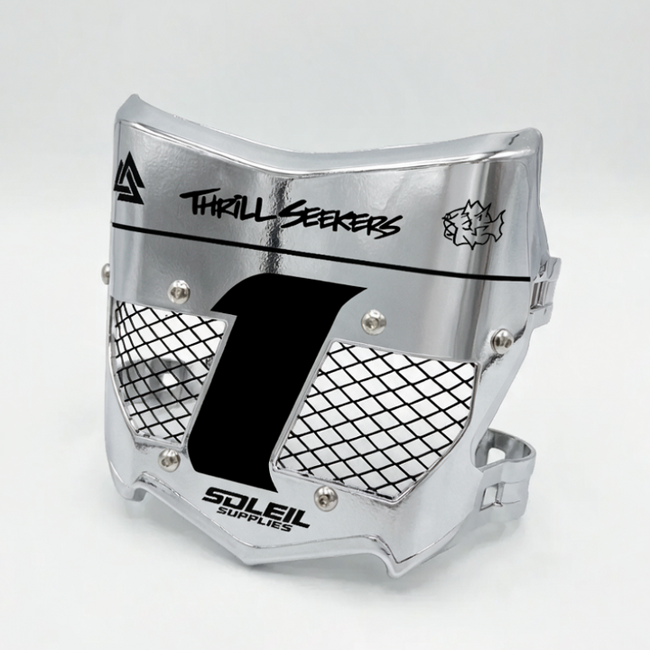 A silver metallic motocross face guard with black mesh grilles, a large black number 1 on the front, and printed branding including &
