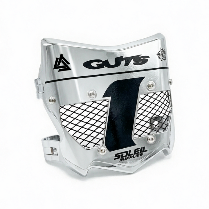 A silver metallic motocross face guard with black mesh panels and printed black branding, including &