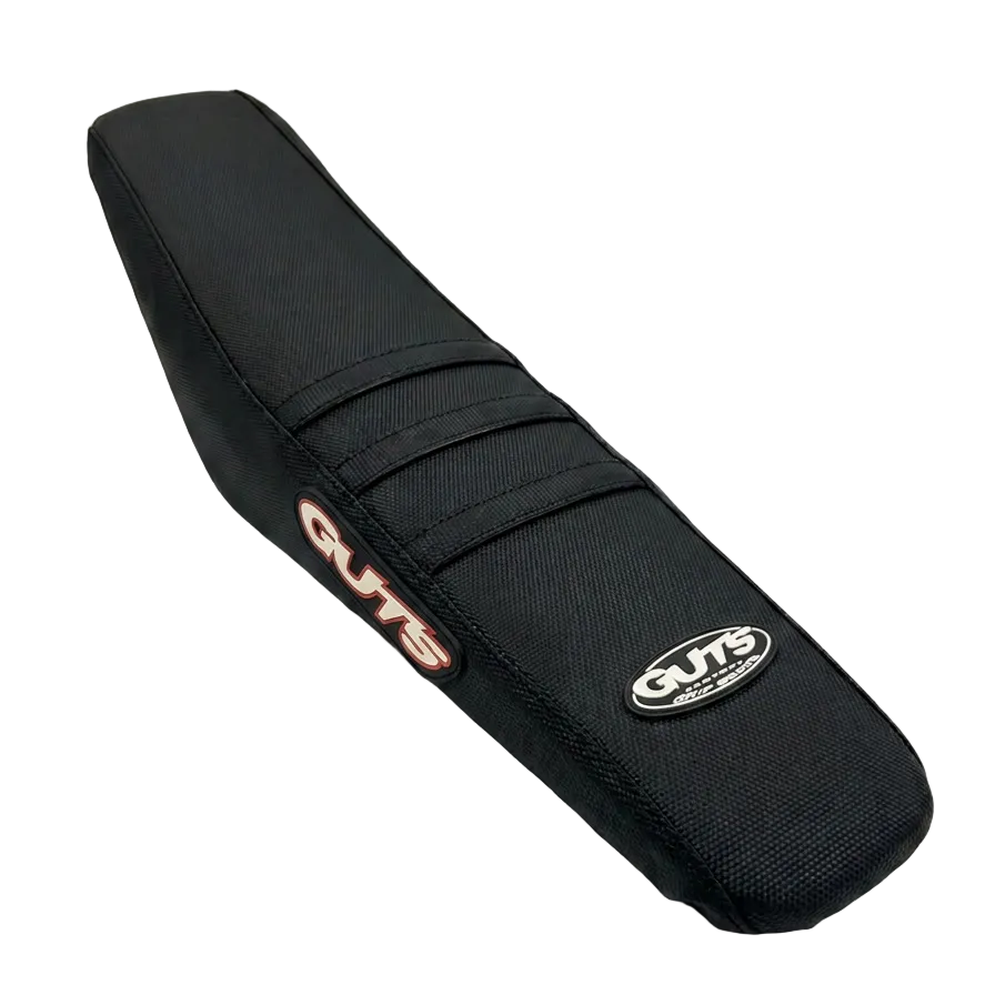 A black motorcycle or scooter seat cover by CUTS, featuring a textured fabric body with a silver and red embroidered logo on one side and a circular silver logo patch on the other, set against a plain light gray background.