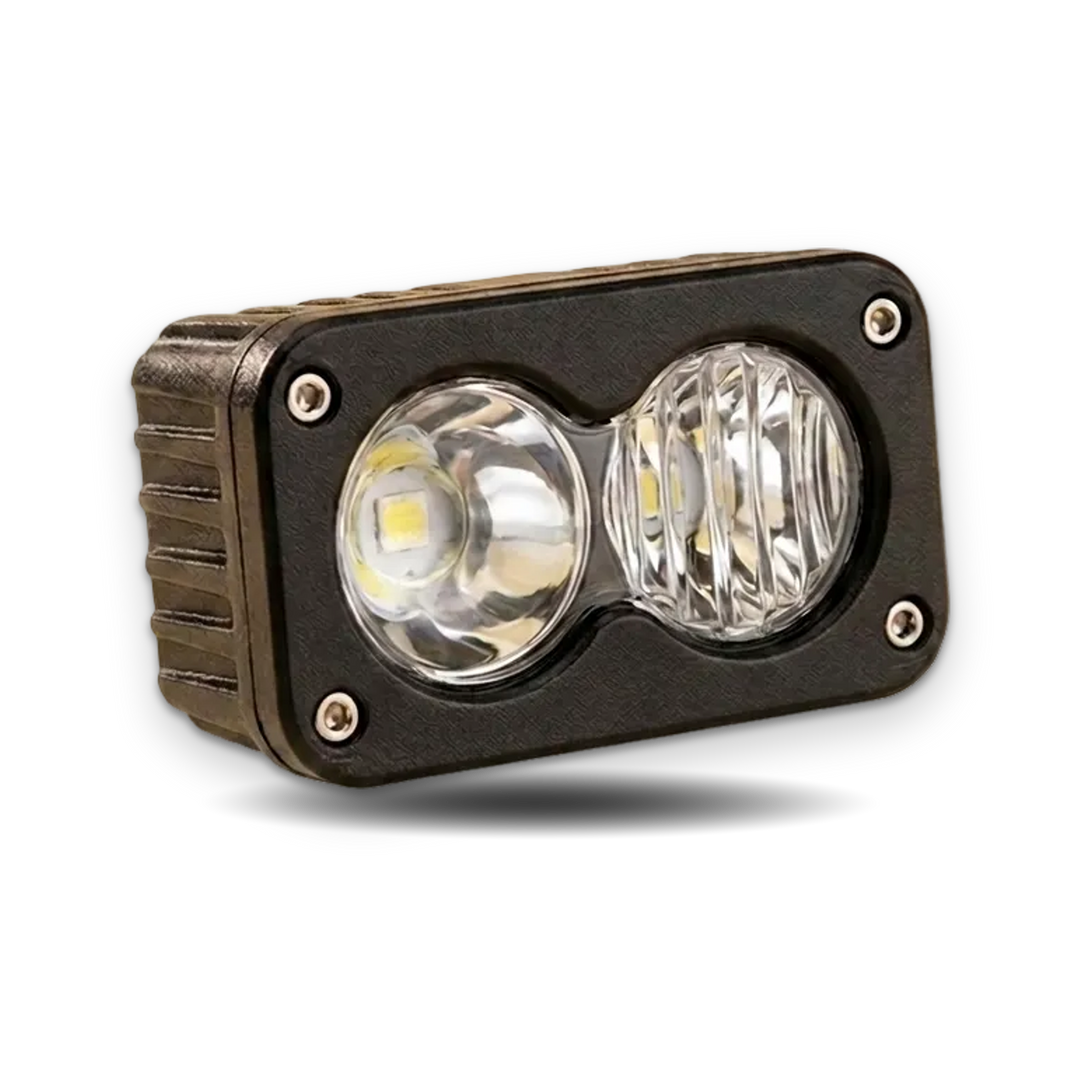 A rugged rectangular LED light fixture with a black metal housing, two front LED lenses, and four visible mounting screws, shown on a plain white background.