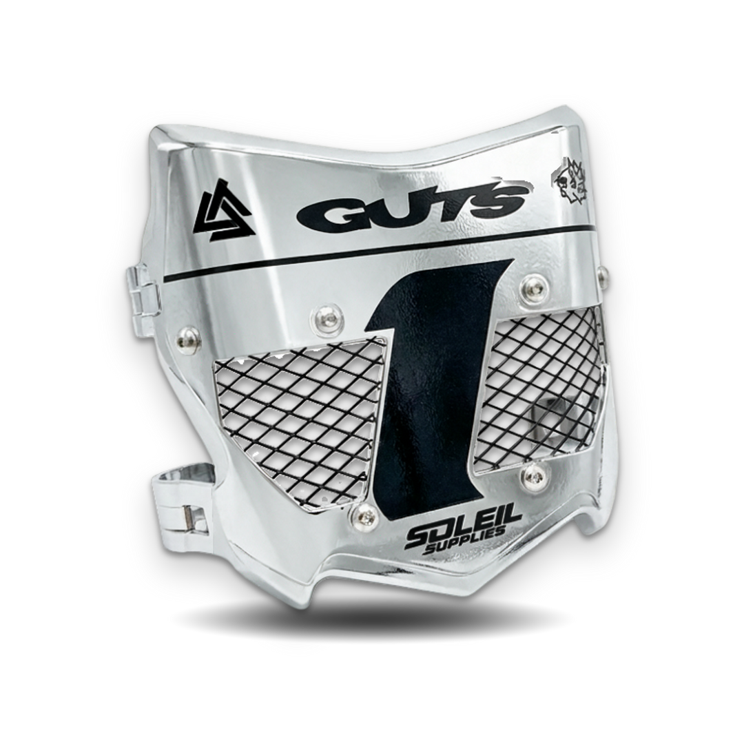A silver metallic motocross face guard with black mesh panels and printed black branding, including &
