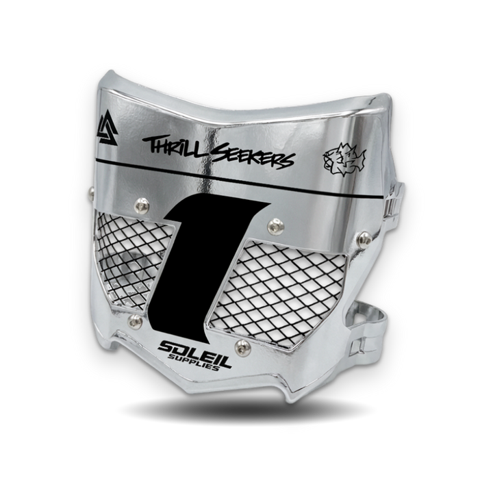 A silver metallic motocross face guard with black mesh grilles, a large black number 1 on the front, and printed branding including &
